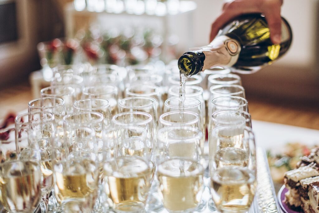 Image sélectionnée par notre agence pour illustrer les métiers de l’événementiel dans la Drôme : service de champagne par des serveurs.